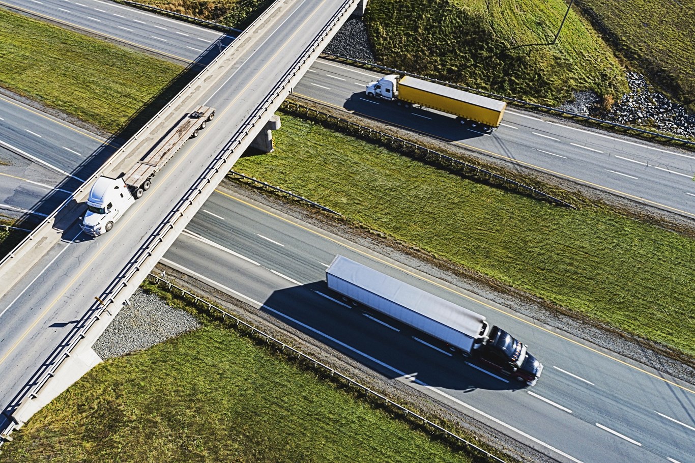 Three semis driving on a Canadian highway