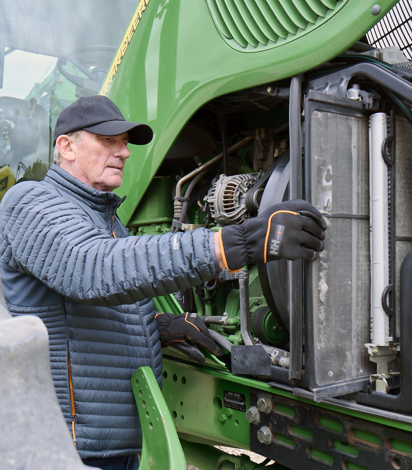 Image of farmer working on tractor