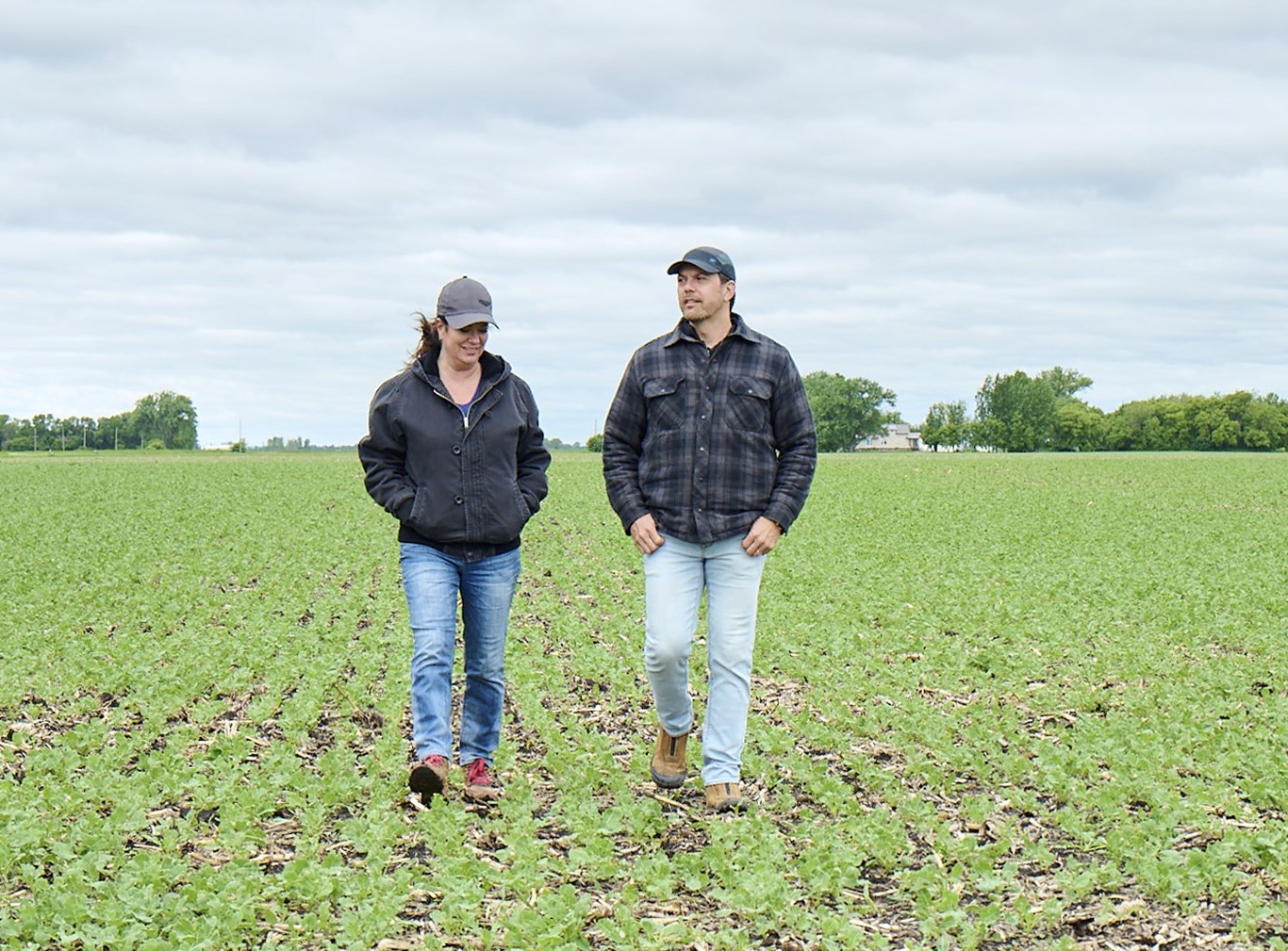 Image of 2 farmers walking through field